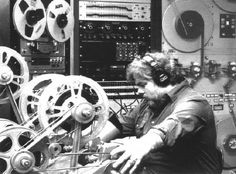 a man sitting in front of some reels