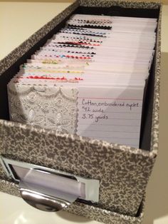 a file cabinet with many files in it on a counter top next to a pen and pencil holder