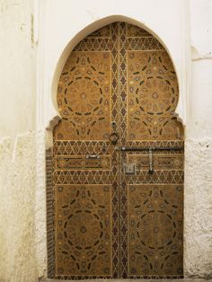 an ornate wooden door with intricate designs on it