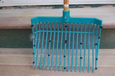 a blue metal grate sitting on top of a sidewalk