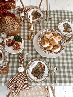 the table is set with plates and silverware