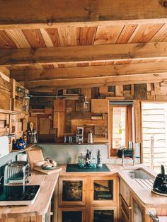 a kitchen with wooden walls and cabinets in it