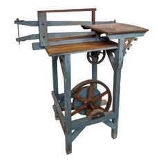 an old spinning machine with wheels and wooden planks on the top, isolated against a white background