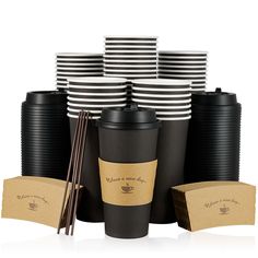 black and white coffee cups with chopsticks next to each other