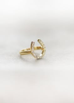 The horseshoe is a powerful symbol of good luck and protection. An elegant and subtle statement ring with a hint of pave diamonds. This ring is available in Sterling Silver, 14 Karat Gold, 14 Karat Rose Gold and 14 Karat White. 1/3 of an inch tall This ring takes 3-4 weeks to make and ship. If you are unsure of your size we can help you out with that! Just select the "Not Sure of my Size" option and we will send a ring sizer to you and confirm your ideal fit. *Kristin Hayes Jewelry is happy to w Horseshoe Jewelry, Horseshoe Ring, Country Rings, Looks Country, Horse Jewelry, Ring Sizer, Instagram Shop, Statement Ring, Pave Diamonds