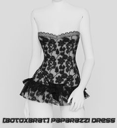 a mannequin wearing a black and white corset with lace on it