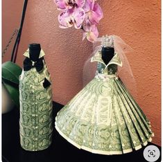 two vases made out of money are sitting next to each other