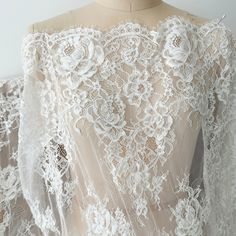 the back of a dress with white lace on it