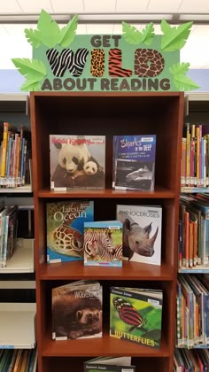 the bookshelf is full of children's books and there are signs above it