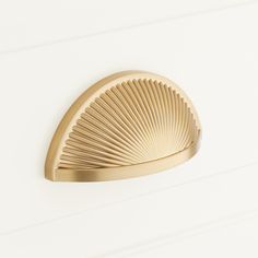 a gold door handle on a white wall