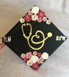 a graduation cap decorated with flowers and a stethoscope