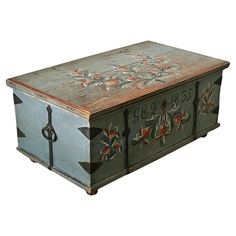 an old wooden box with floral designs painted on it