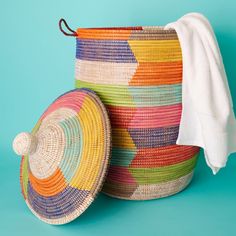 Large size nesting storage basket set with hooded lids in colorful pattern. Large basket measures approx. 17" diameter, 23" without hood, and 30" height with hood. Medium basket measures approx. 15" diameter, 19" without hood and 25" with hood. Small basket measures approx. 12" diameter, 14" without hood, and 20" with hood. For storing laundry, toys and blankets. Woven from grass and recycled plastic ribbons using traditional coil weaving technique. Handmade by Wolof tribe women in Senegal, Afri Hooded Lids, Cotton Basket, Colorful Baskets, Grass Basket, Basket Crochet, Large Storage Baskets, Handmade Baskets, Craft Markets, How To Make Ribbon