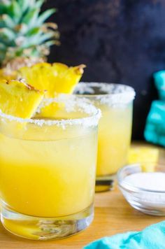 a pineapple margarita is garnished with sugar