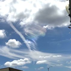 an airplane is flying in the sky over some buildings