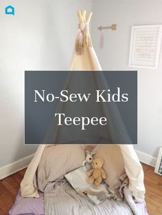 a teepee tent sitting on top of a bed in a child's room