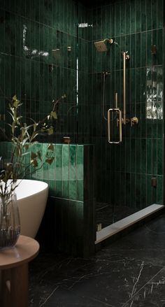 a green tiled bathroom with a tub and shower