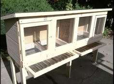 a large wooden bird cage sitting on top of a bench