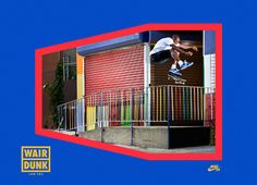 a skateboarder is doing a trick in the air over a building with red and blue walls