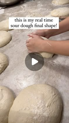 a person kneading dough on top of a table