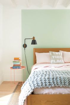 a bedroom with a bed, nightstand and two lamps on either side of the bed