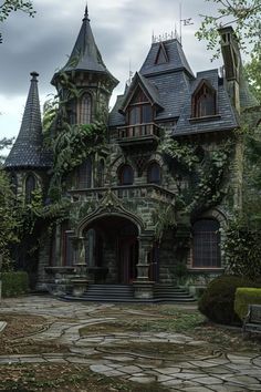 an old gothic - style house with ivy growing on the walls and roof, surrounded by stone steps