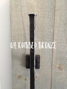 an old door handle with the word oil rubbed bronze painted on it's side