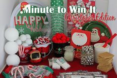 a table topped with lots of candy and christmas items next to a sign that says, minute to win it