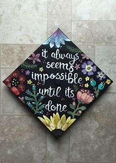 a decorated graduation cap that says it always seems impossible until it's done one