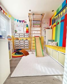 a child's playroom with colorful walls and flooring, including a climbing ladder