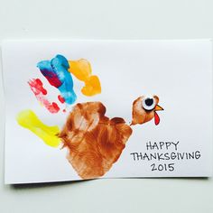 a happy thanksgiving card with a handprinted turkey