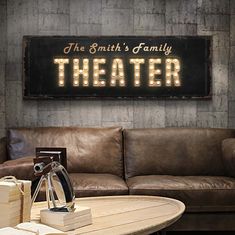 a couch and table in a room with a sign on it that says the smith's family theater