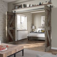 a living room filled with furniture next to a bed and a wooden table on top of a hard wood floor