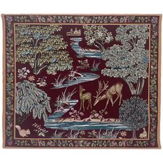 a tapestry with deers and trees on it