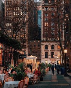 people are sitting at tables in the city