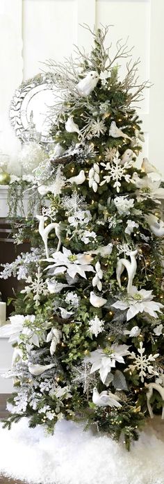 a christmas tree with white and silver decorations