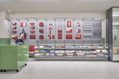 the interior of a book store with many books on shelves and two green bins