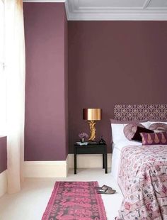 a bedroom with purple walls and white carpet