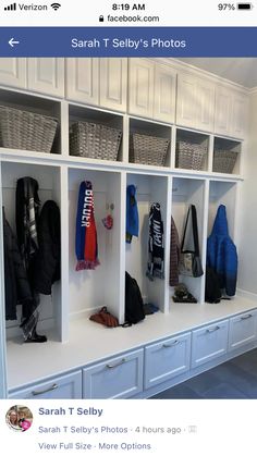 an image of a white coat rack with many coats on it