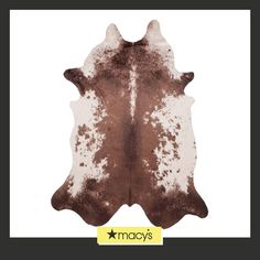 a brown and white cowhide rug with the words macy's written on it