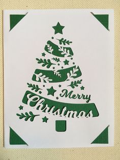 a green and white christmas card with a tree in the shape of a star on it