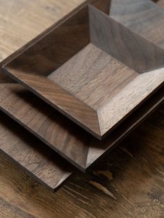 three wooden trays sitting on top of each other