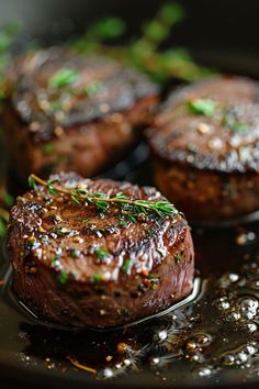 steaks with herbs and seasoning in a pan