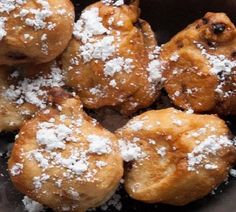 powdered sugar on top of pastries in a bowl