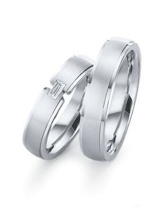 two wedding rings with diamonds on each side