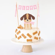 there is a cake that has a dog on it and some sticks sticking out of it