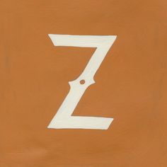 the letter z is painted white on an orange surface with a black dot at the bottom