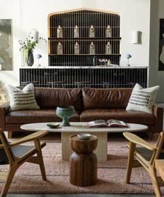 a living room filled with furniture and a book on top of a wooden coffee table