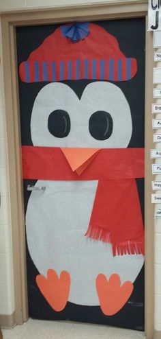 a door decorated with a penguin wearing a hat and scarf