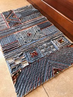 a blue area rug on the floor next to a drawer